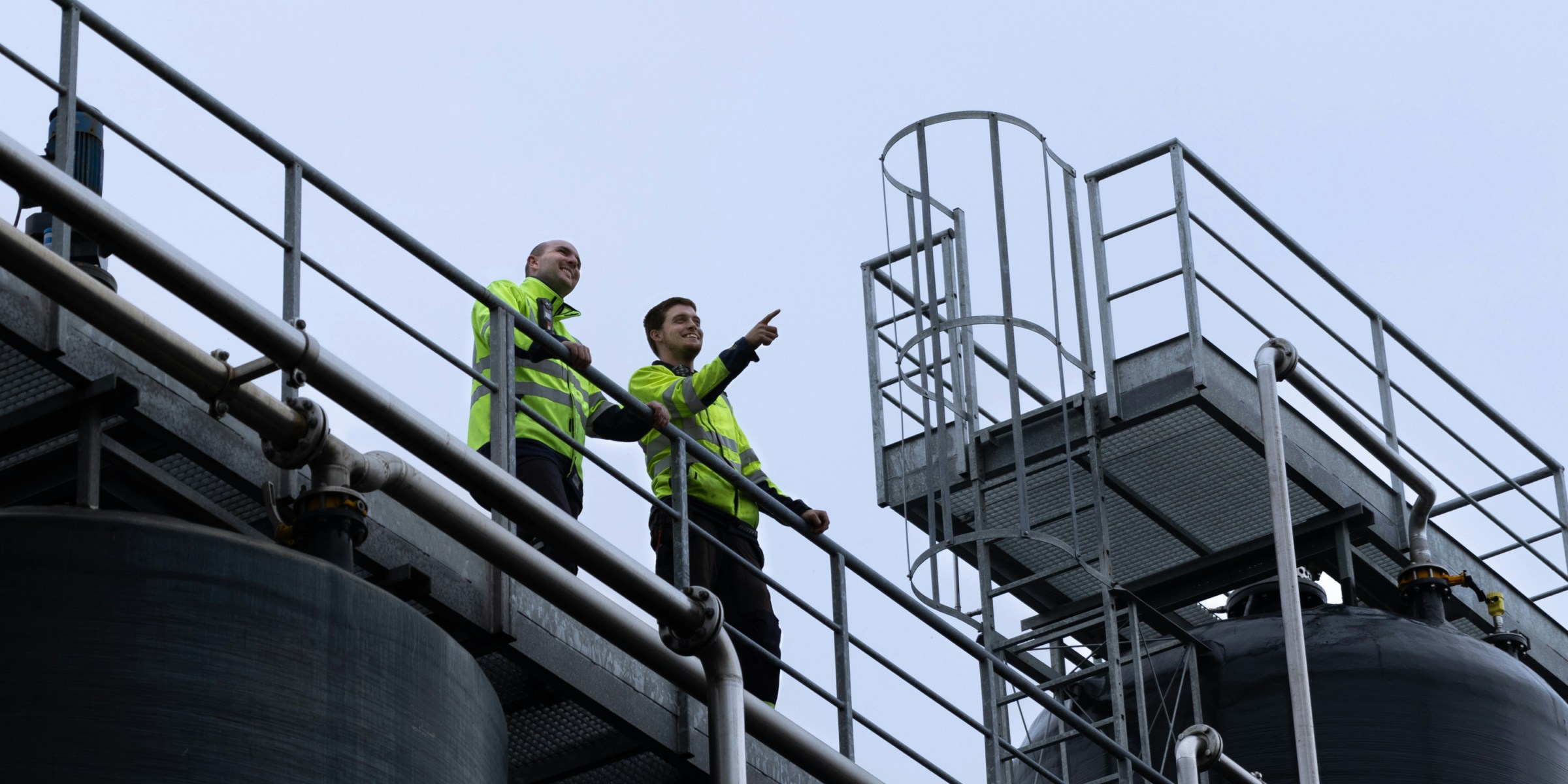 Employees on top of a biogas plant